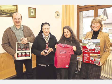 T-Shirts, Bier, Kalender und ein besonderer Likör: Mit Produkten wie diesen und einem umfangreichen Festprogramm lädt Schlehdorf alle Bürger zum Jubiläumsjahr ein. Die Souvenirs, die (v. li.) Bürgermeister Stefan Jocher, Sr. Josefa Thusbaß, Gabi Oehm (Tourismusverein) und Gemeinderätin Justina Eibl zeigen, gibt’s nur im Dorfladen zu kaufen. Foto: pröhl T-Shirts, Bier, Kalender und ein besonderer Likör: Mit Produkten wie diesen und einem umfangreichen Festprogramm lädt Schlehdorf alle Bürger zum Jubiläumsjahr ein. Die Souvenirs, die (v. li.) Bürgermeister Stefan Jocher, Sr. Josefa Thusbaß, Gabi Oehm (Tourismusverein) und Gemeinderätin Justina Eibl zeigen, gibt’s nur im Dorfladen zu kaufen. Foto: pröhl